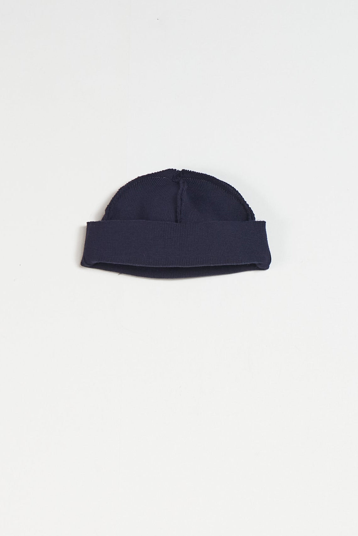 Navy blue beanie on a white background